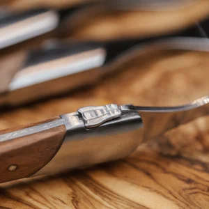 Close-up of the bee and bolster on a Laguiole Du Monde rosewood fork
